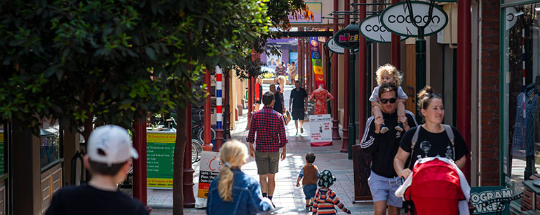 People walk past shops in Timaru’s historic glass and steel arcade