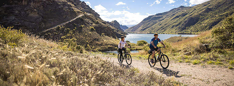 People bike around Lake Dunstan in Central Otago