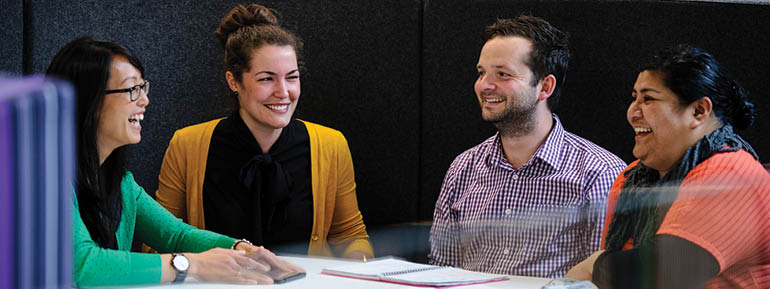 Decorative text: four MBIE staff around a table.