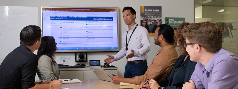 Decorative image: staff in a meeting room