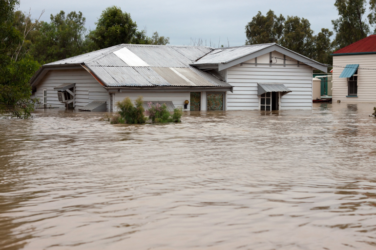 A house half under flood water. 