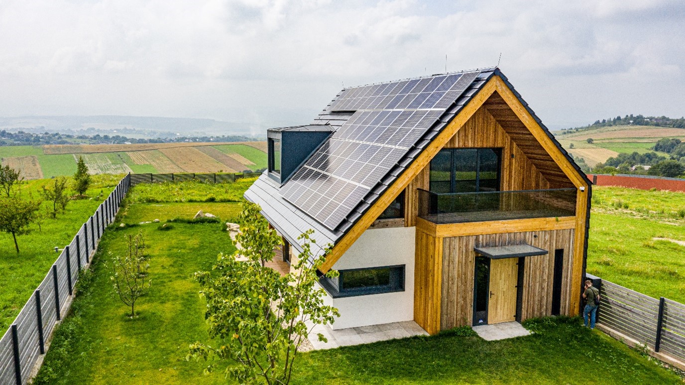 Passive house with solar panels on the roof and built from natural materials.