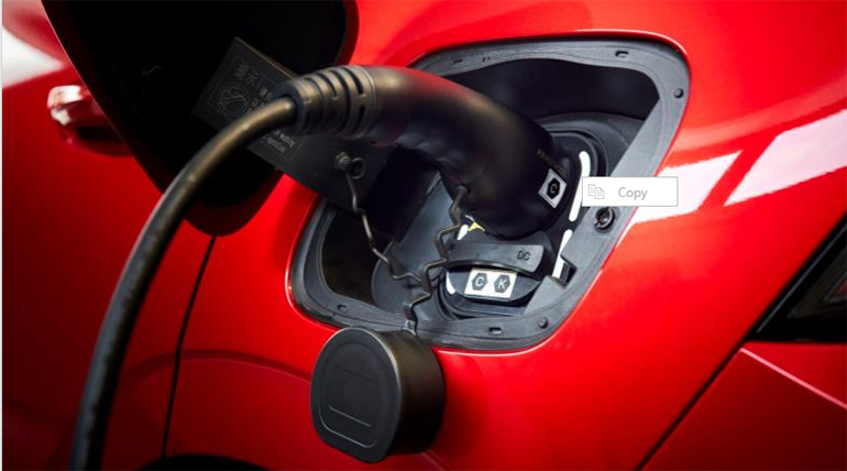 Red car being charged