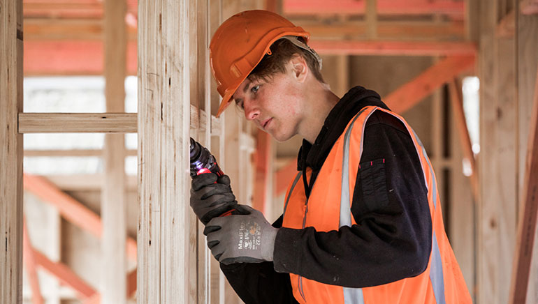 apprentice working on a building site.  