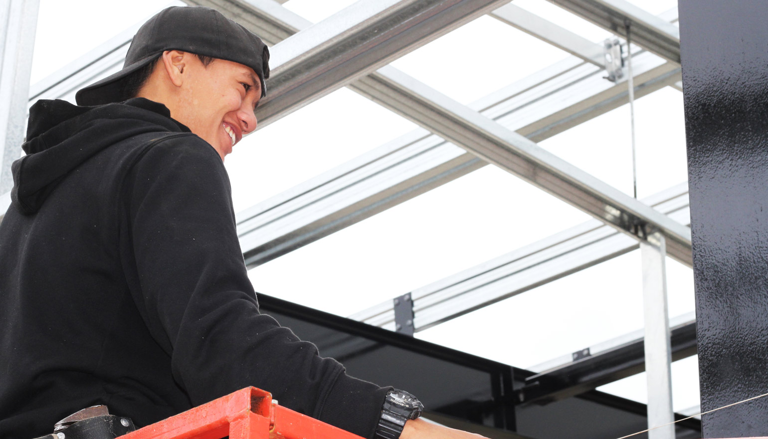 Youth with backwards cap on a cherry picker