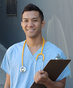 A young male nurse with patient notes and stethoscope