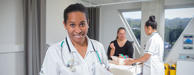 Pasifika student nurse reading over patient notes.