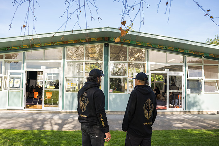 Backs of two males at Te Aratika Academy