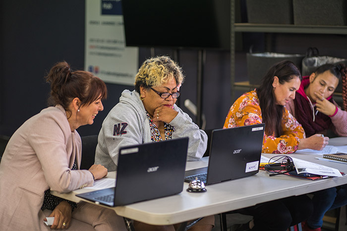 Four females job searching at a computer 