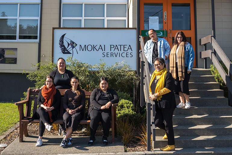 7 women outside a building with a sign that reads ‘Mokai Patea Services’.