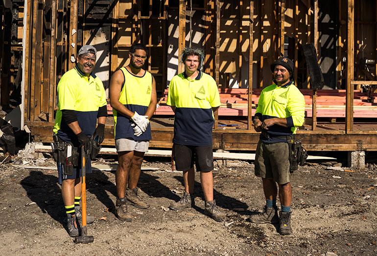 Four men on building site 
