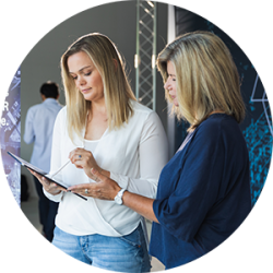 Two women looking at a tablet.