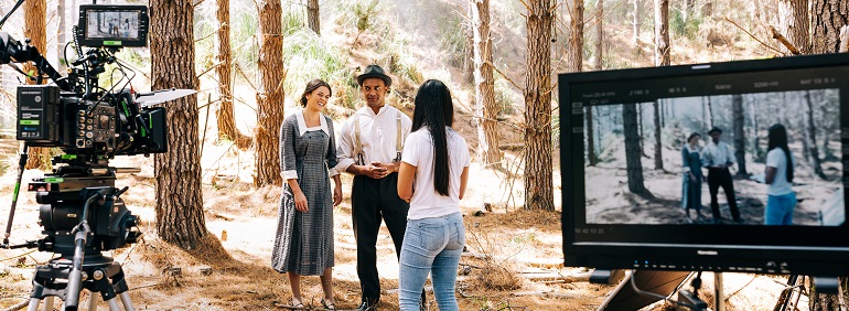 Three actors in a forest ready to shoot a scene.