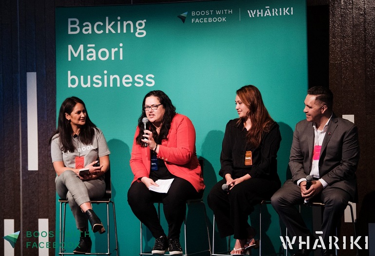 4 People on stage as a panel with words of Backing Maori Business in background.
