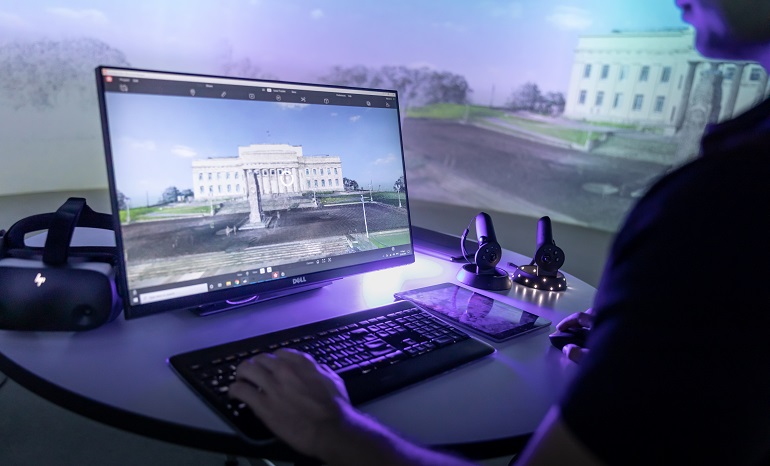 Person at a computer looking at an image of the Auckland War Memorial Museum.