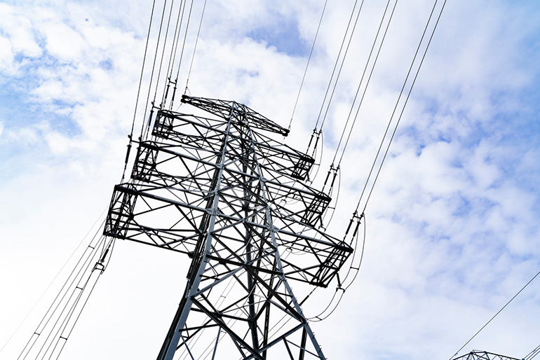 A pylon against a blue, cloudy sky.