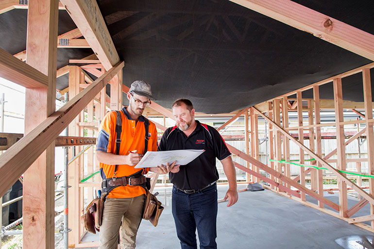 2 builders looking at a plan.