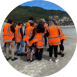 Photograph of school students in orange high vis vests at Fulton Hogan site watching asphalt being made