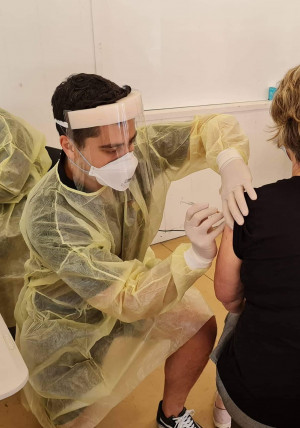 COVID Health worker vaccinating a person