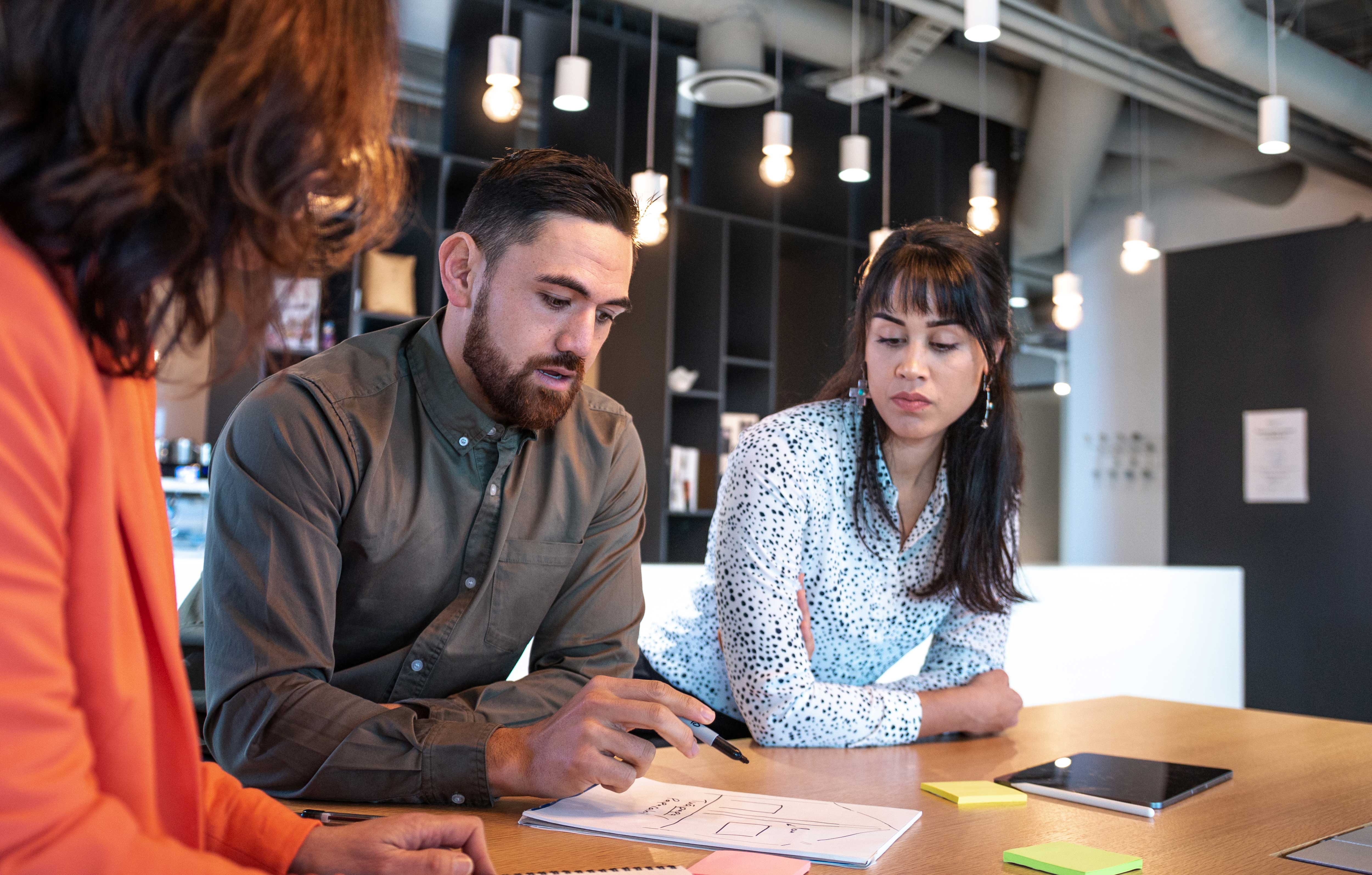 Group of three people having a planning meeting