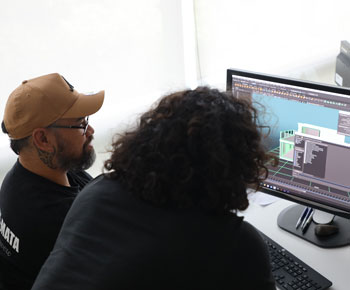 Two people looking at a computer screen