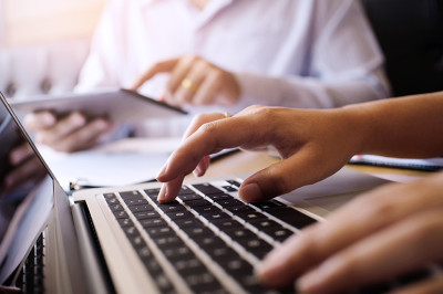 Hands typing on keyboard.