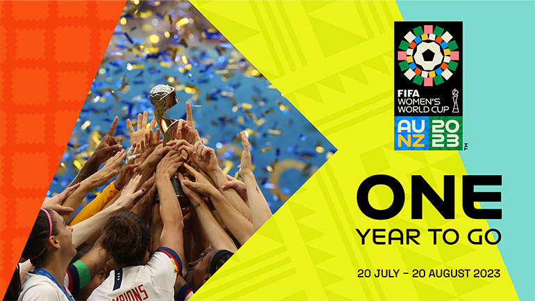 Group of women footballers holding trophy aloft. Text on image states there is one year to go until the tournament which will be held from 20 July to 20 August 2023.