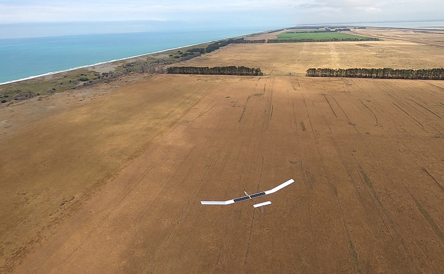 Glider flying over fields