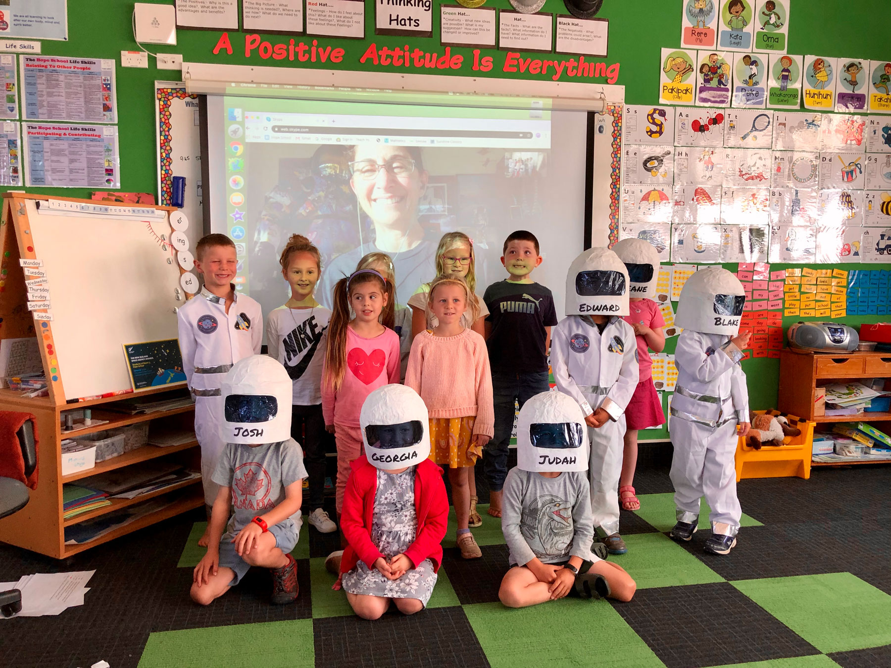 The young space travellers of Room 3 at Hope School stand in front of their live video chat with Nicole Stott, former NASA Astronaut.