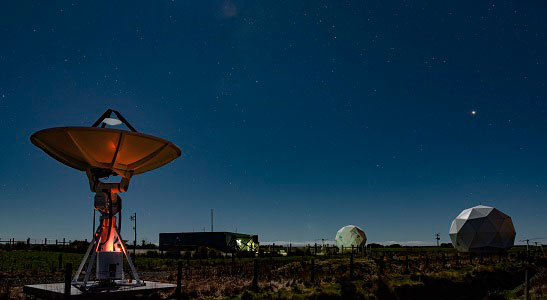 A radio telescope pointed towards the night sky