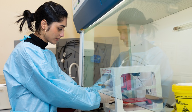 Photo of University of Waikato researcher in lab.