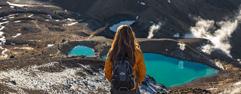 Backpacker looking at mountainous terrain