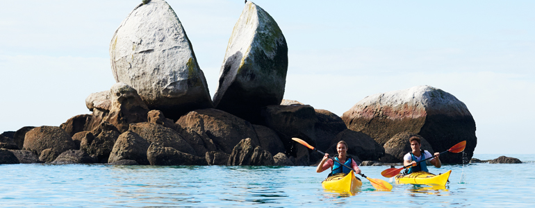 Couple on kayaks in Abel Tasman