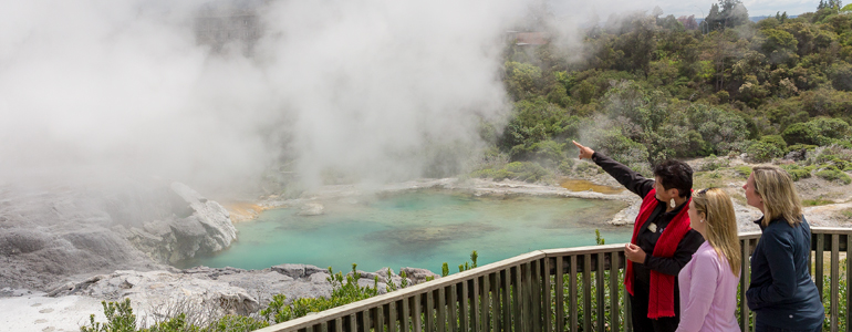 Guide pointing out the geothermal steam to tourists.