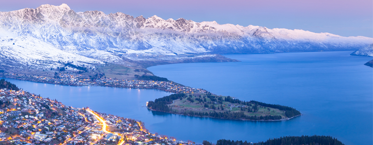 Queenstown at dusk with mountains and lake