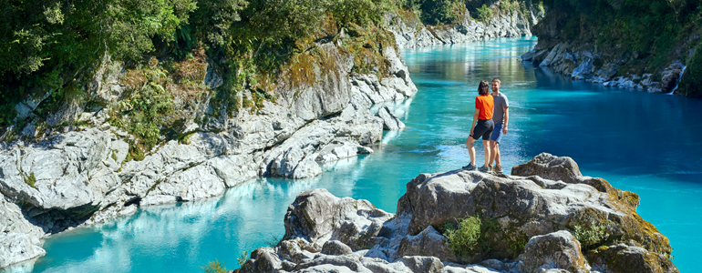 Couple on rocks overlooking river