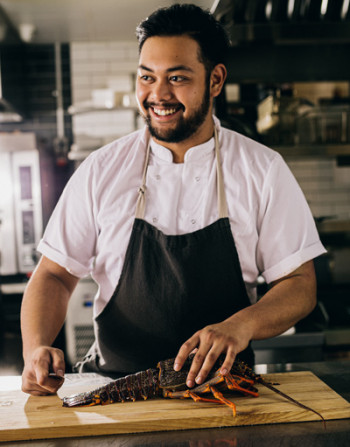 Chef cutting crayfish