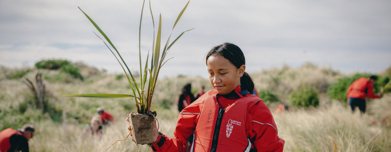 child holding plant 770x300