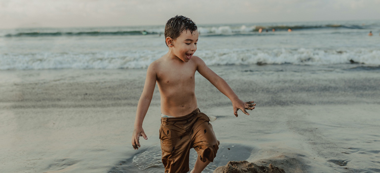 kid playing in the sand 770x350