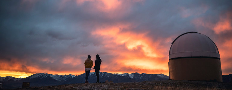 two people at observatory at sunset 770x300