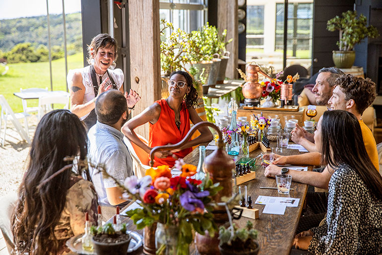 A hospitality worker entertaining customers at a vineyard in Waiheke, Auckland. 