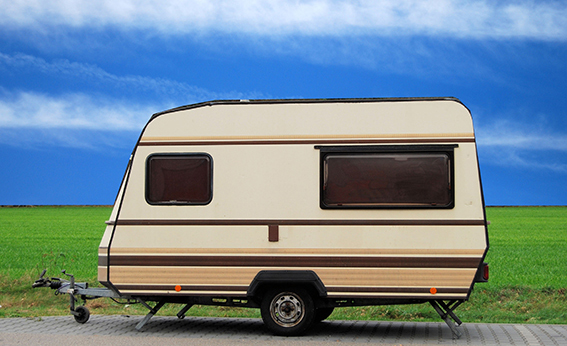 Vintage caravan on parking lot with blue sky