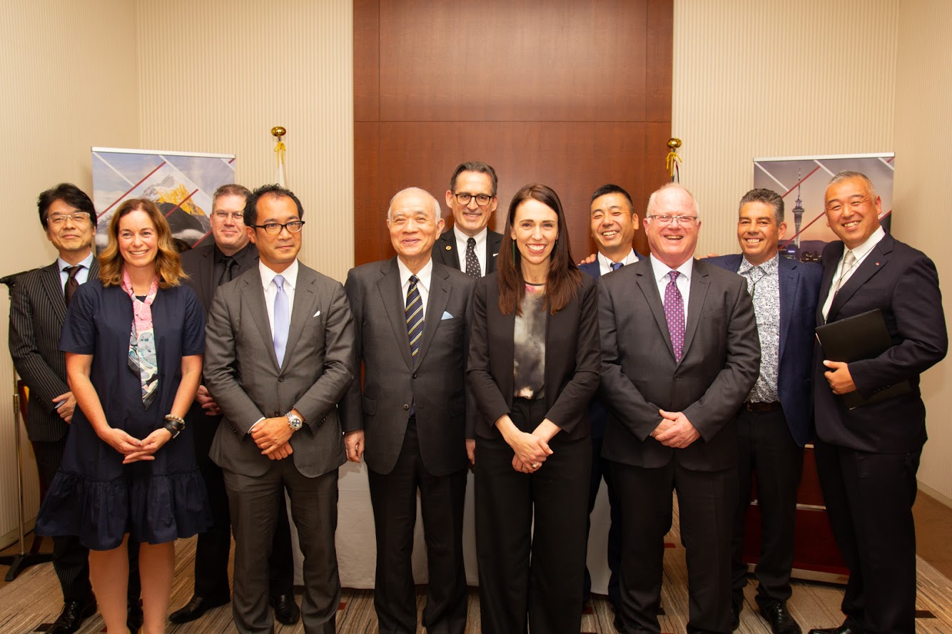 Prime Minister Jacinda Ardern poses with other New Zealand and Japanese researchers and innovators at the NZ Embassy in Tokyo.